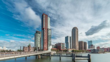 Hollanda, Rotterdam 'da bulunan ve yerel olarak Hoerenloper olarak bilinen Rijnhaven Köprüsü' nden Hiperlapse. Arka planda modern gökdelenleri ve bulutlu gökyüzü olan bir yaya ve bisiklet köprüsü