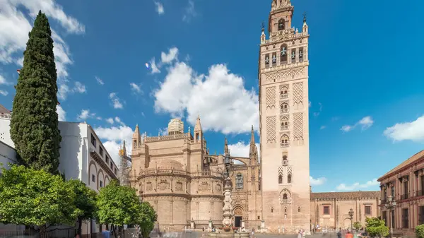 Seville Katedrali ve Giralda Kulesi Sevilla, İspanya 'da zaman atlaması. Dünyanın en büyük gotik katedrali olan UNESCO miras alanı Virgen de los Reyes Meydanı 'nda mavi gökyüzünün altında yer almaktadır.