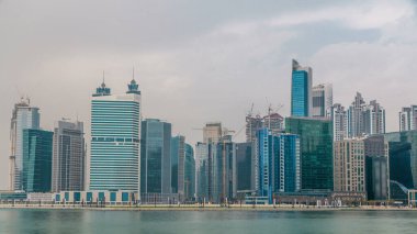 İş Körfezi ve şehir merkezinin panoramik timelapse görünümü alan Dubai yansıma bir nehir. Modern gökdelenler ve bulutlu gökyüzü