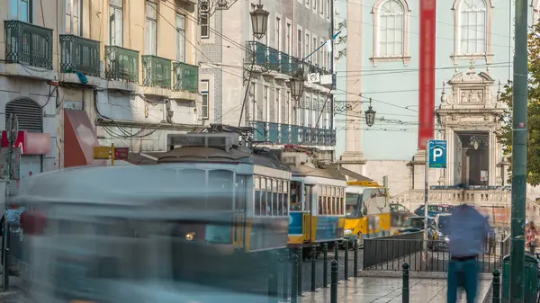 People getting on the tram timelapse, at a station in Luis de Camoes square, in the neighborhood of Chiado. Traffic on the street with cars and public transport