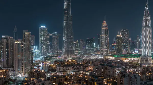 Dubai Şehir Merkezi Ufuk Çizgisi gecesi Burj Halife ve Dubai 'deki diğer panoramik manzaralı Birleşik Arap Emirlikleri. Çember yollarda ve çeşmelerde trafik vardı. Geleneksel ve modern binalar.