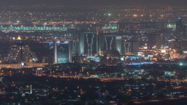 Deira ve Dubai deresinin hava manzaralı tipik eski ve modern binalar gece zaman ayarlı. Arka planda havaalanı var. Gökdelen çatısından bak. Dubai, Birleşik Arap Emirlikleri