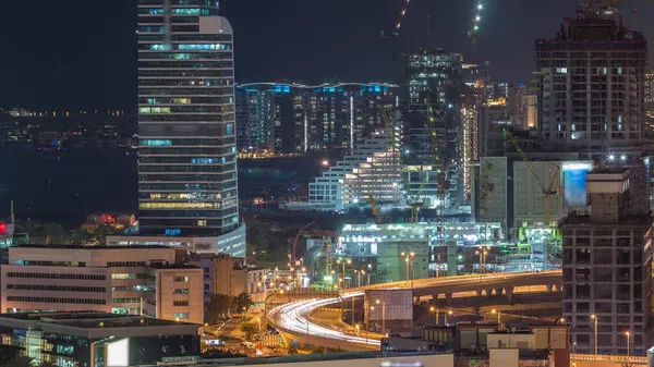 Palm Jumeirah gece timelapse, Dubai, Birleşik Arap Emirlikleri Dubai medya şehir gökdelenler ve şantiye. Yolda trafik ile Yeşiller bölgesinden havadan görünüm