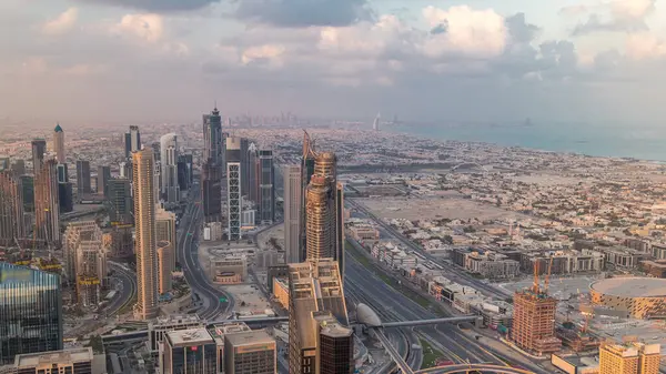 Dubai Downtown silueti fütüristik cityscape birçok gökdelenler ve iş bölümü hava timelapse ile. Modern kuleler ve çatıdan inşaat ile gün doğumu sırasında Sabah panorama
