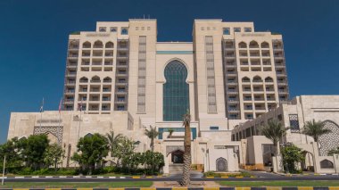 Ajman 'da 5 yıldızlı lüks bir otelin girişinde, UAE' nin Arap Körfezi turkuaz sularının yakınındaki bir yolda trafik vardı..