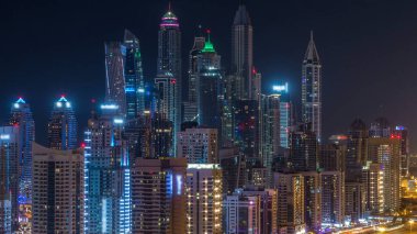 Dubai Yat Limanı timelapse tüm gece boyunca muhteşem çatı manzarası. Işıklandırılmış gökdelenler, Birleşik Arap Emirlikleri, dönüm büyük bir şehir. Hava Jlt görünümünden