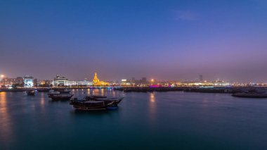 Geleneksel ahşap Dhow balıkçı tekneleriyle Doha Körfezi 'nde gece gündüz geçiş zamanı. Corniche, Doha, Katar ile müzeden görüntü