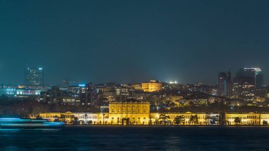 Illuminated Mimar Sinan University night timelapse. View to besiktas district in Istanbul taken from asian part of the city. Reflection on Bosphorus water