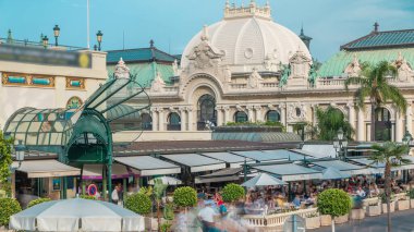 Kumarhane Meydanı. Monte Carlo 'da Casino zamanının yakınında bir kafe. İçerideki masada oturan insanlar. Güneşli yaz günü