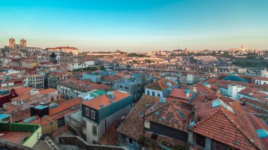 Sunset time, shadow covering Douro riverside with the Dom Luiz bridge and Mosteiro da Serra do Pilar, Porto aerial panoramic timelapse, Portugal. Warm evening light
