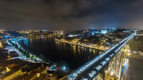 Night aerial view of the historic city of Porto, Portugal panoramic timelapse with the Dom Luiz bridge from above