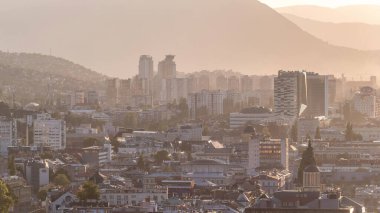Bosna-Hersek 'in tarihi Saraybosna şehir merkezinin panoramik hava manzarası, ünlü binalar ve gün batımından önce puslu havayla çevrili