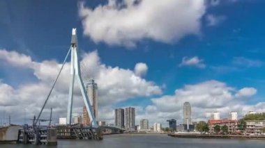Rotterdam, Hollanda 'daki Maas Nehri' ni kapsayan Erasmus Köprüsü zaman atlaması. Hollandlar 'ın en büyük kablo destekli basküle köprüsü gökdelenleri, rıhtımdaki botlar ve dramatik bulutlu gökyüzü arkaplanı