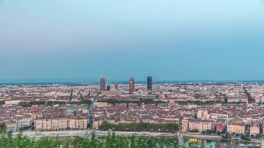 Gün batımından sonra Lyon 'un panoramik hava görüntüsü Fourviere Hill' den gece dönüşümüne kadar. Ufuk çizgisinde Rhone Nehri ve sıcak bir akşamda aydınlanan ikonik kent simgeleri yer alıyor.