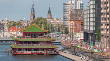 Sudaki pagoda biçiminde bir Çin restoranının havadan görünüşü, tarihi şehir merkezi binaları ve modern mimari zaman aralığının zeminine göre ayarlanmış. Amsterdam, Hollanda