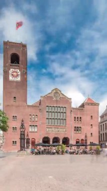 Beursplein 'in tarihi Beurs van Berlage binası, eski bir emtia borsası, şimdi de konserler ve sergiler için bir mekan. Meydanda yürüyen insanlar. Amsterdam, Hollanda