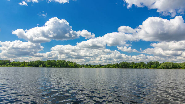 Boats floats on the Moskva River past the Zhivopisny Bridge and other famous places timelapse hyperlapse, Russia. View from motor boat at sunny summer day with cloudy sky