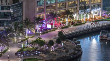 Dubai Marina Havaalanı 'ndaki restoranın rıhtımında gezinti zamanı. Kanalda yüzen tekne ve yatlar. Dubai, Birleşik Arap Emirlikleri
