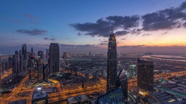 Dubai Uluslararası Finans Merkezi semt, gece den gündüze geçiş saati ne zaman ışıklı modern gökdelenler ile. Gün doğumundan önce sokaklarda trafik ile Downtown havadan görünümü