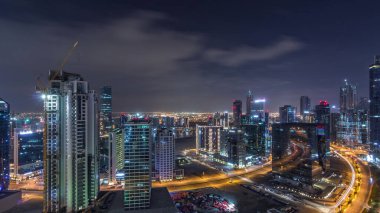Aydınlatılmış binaların hava görüntüsü tüm gece boyunca zaman ve kanal yakınlarındaki yollarda yüksek trafik. Business Bay, Dubai 'de gece hayatı, Birleşik Arap Emirlikleri