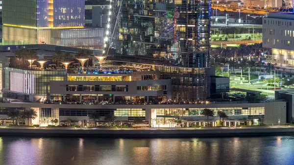 Abu Dabi şehir merkezinin gökdelenleri aydınlık gökdelenlerle dolu gece saatinden itibaren havadan ufuk çizgisi..