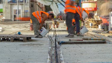 Tramvay rayları entegrasyonun son aşamasında zaman ayarlı beton plakalara bağlanıyor. Titreşim ve gürültüyü azaltmak için sıvı reçineyle doldurulmuş. Tramvay raylarının yeniden inşası.