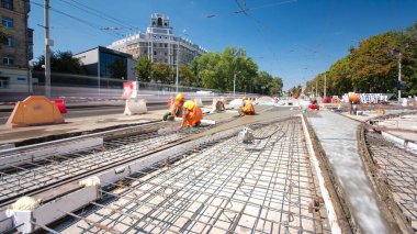 Beton yol yapım birçok işçi ve mikser timelapse hyperlapse ile çalışıyor. Harç metal takviye için dökme. Kaplama ve koruyucu filtre püskürtücü tarafından. Tramvay parça yeniden inşası