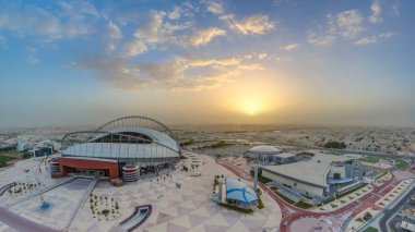 Doha 'da güneş doğarken Aspire Bölgesi' nin havadan görüntüsü. Yollarda ve araba parklarında trafik vardı. Sisli hava