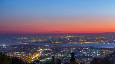 Istanbul night skyline scenery day to night transition timelapse, aerial view over Bosporus channel from Camlica hill. Blue water of Bosporus channel with ship. Traffic on roads