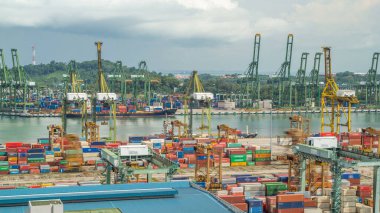 Port of Singapore timelapse from above. Bird eye panoramic aerial view of busiest Asian cargo port with hundreds of ships loading export and import goods and thousands of containers in harbor