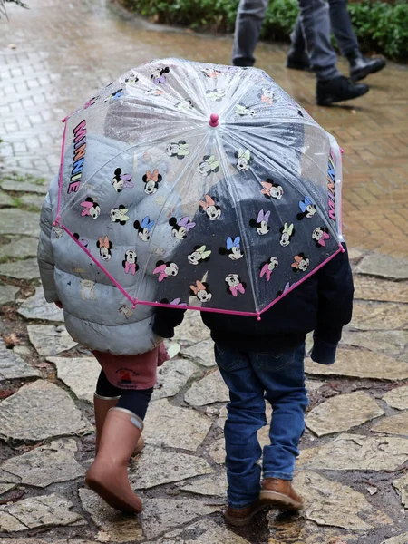 Two Children Walk Together Rain Minnie Mouse Umbrella — Stock Photo, Image