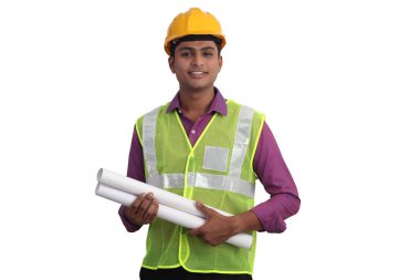 Sarı kask takan Hintli erkek mimar ve güvenlik ceketi elinde beyaz arka planın planları var. 