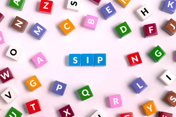 stock image top view on colorful cubes with letters, word SIP made of blue on pink background