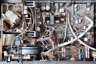 Old dusty electronic board of the tape recorder. Old electronic circuit.