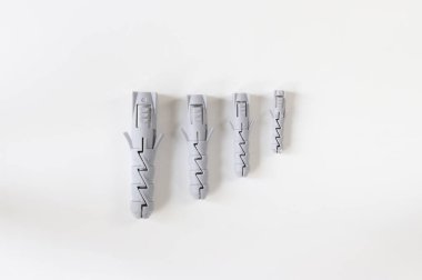 Dowels on a light background. Construction dowels of different diameters.