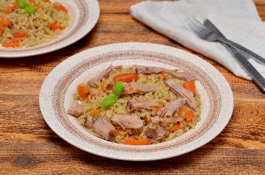 plate with pilaf with meat on the table