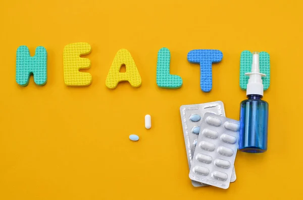 drugs and word health on yellow background, concept image