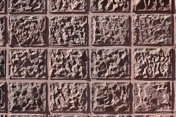 texture of a relief wall in a pink tone close-up