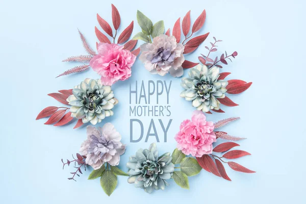 Happy Mother\'s Day Pastel Blue and Pink Colored Background. Flat lay floral greeting card with beautiful silk flowers.