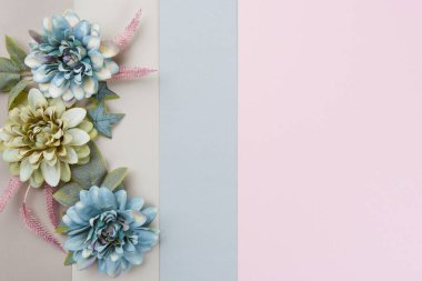 Happy Mother's Day, Women's Day, Valentine's Day or Birthday Pastel Colored Background. Floral flat lay greeting card template with beautiful silk flowers.