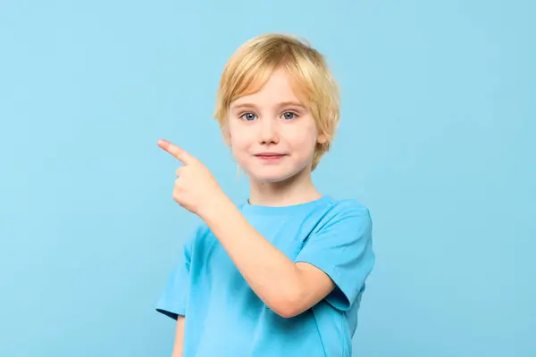 Portrait Cute Little Boy Blond Hair Smiling Pointing Empty Place — Stock Photo, Image