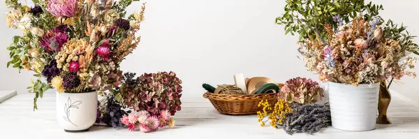 Dried flowers banner. Arranging dried flowers into a beautiful bouquet. Sustainable floristry. Creating home decor with dried flowers.