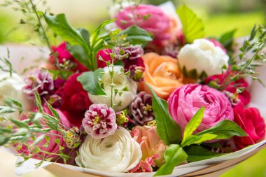 Bahar buketi. Güzel pastel renkli taze çiçek aranjmanı. Açık havada çekilen ranunculustan yapılmış doğum günü buketi.. 