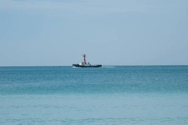 View of a pilot\'s boat sailing in the blue ocean sea with a foam wake