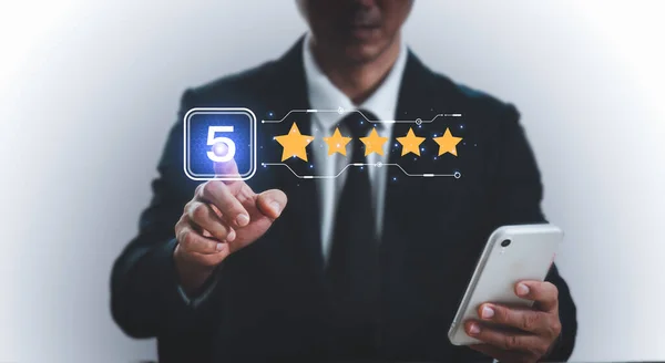A man points with his finger and selects a number five and a five star to display on the virtual screen. The user experience or customer satisfaction survey, poll, or questionnaire.