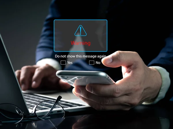 phishing email warning pop-ups, spam email, and network security concept blocking. A businessman sees a warning popup while working on his laptop at home