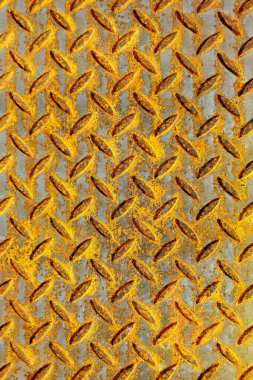 Rusty corrugated metal sheet with a diamond pattern showcasing textures and colors. clipart