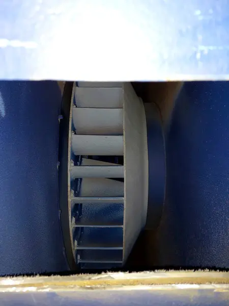 stock image A close-up view of a large industrial exhaust fan impeller inside its casing, showcasing the blades and design.