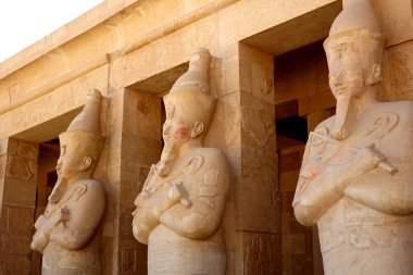 The magnificent ancient statues stand majestically at the Mortuary Temple of Hatshepsut in Deir el Bahri, showcasing remarkable architectural achievements of the time. clipart