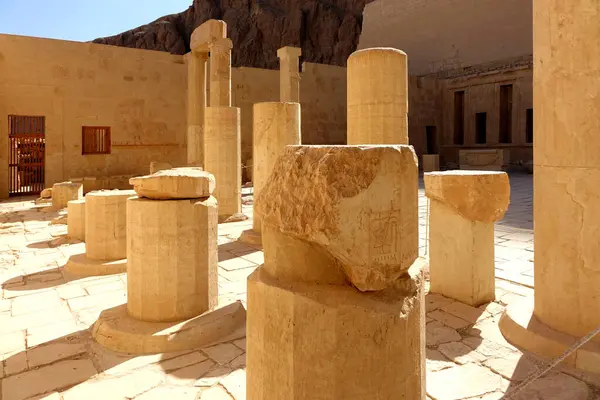 stock image Visitors wander through the ruins of the Mortuary Temple of Hatshepsut in Deir el Bahri, surrounded by ancient columns and stone structures